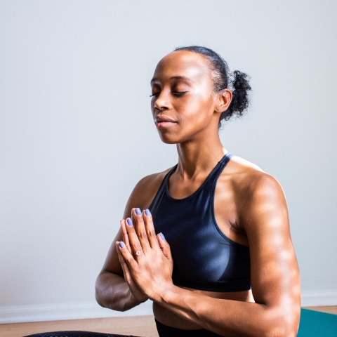 Person seated in prayer pose