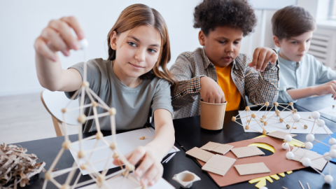 Tweens building small wooden structures