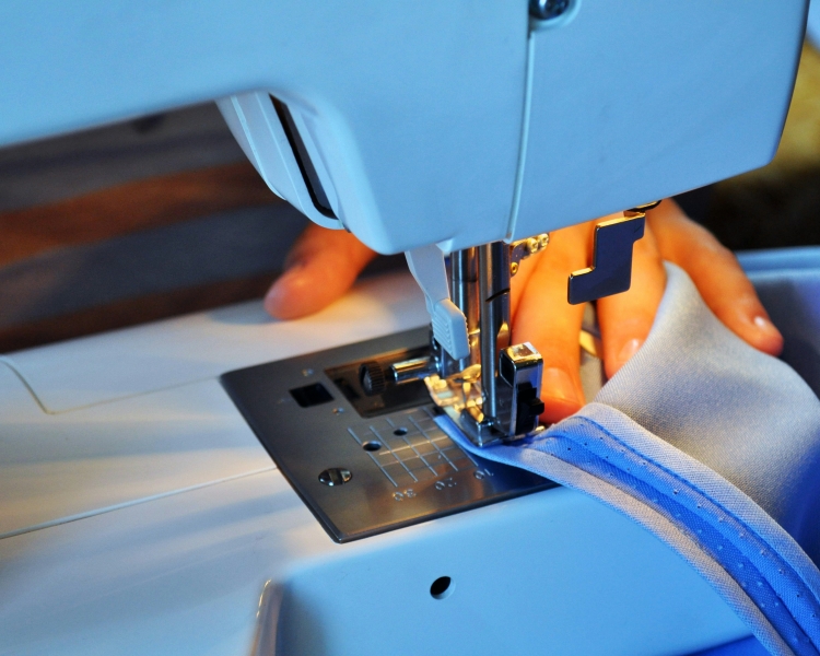 Person sewing on electric sewing machine